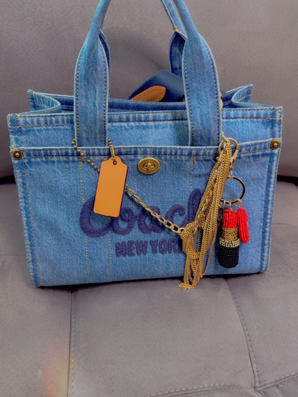 Coach Denim Tote in Light Blue with Gold-Tone Hardware and Red Accent Charm